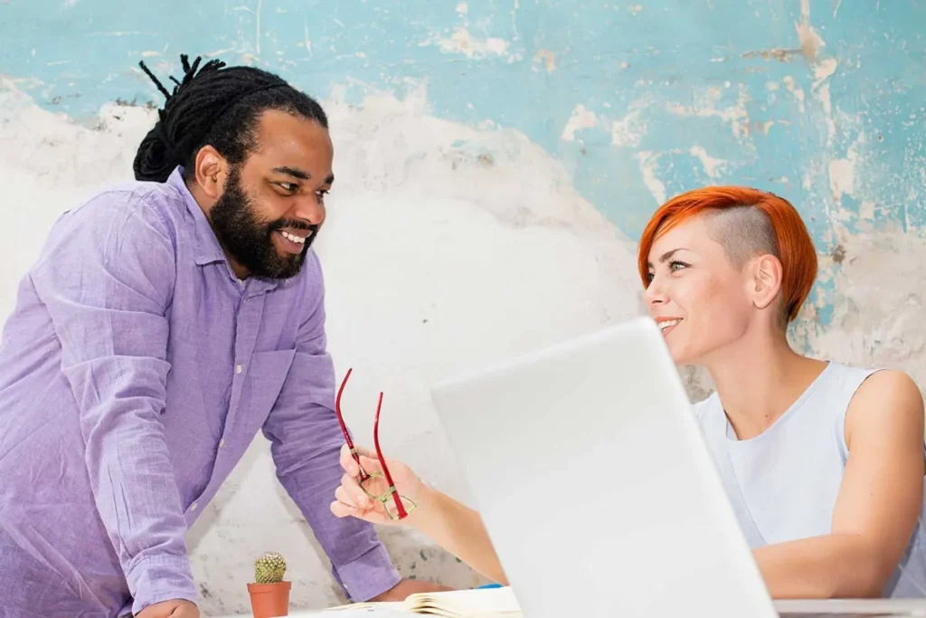 creative team working together on laptop in modern office environment